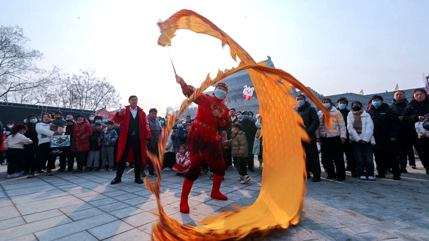 民间艺人在河南省商丘古城南门里的古城大集上表演民俗节目。李恒摄