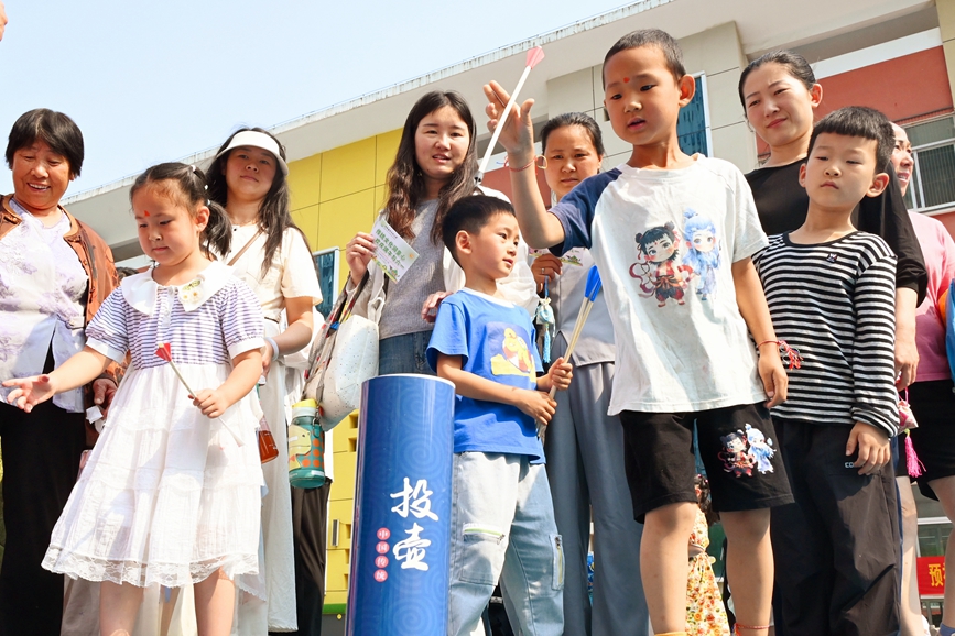 5月28日，河南省南陽市社旗縣第三幼兒園舉辦“雙節同慶 童心‘粽’在”親自游園活動，孩子們在玩趣味投壺游戲。申鴻皓攝