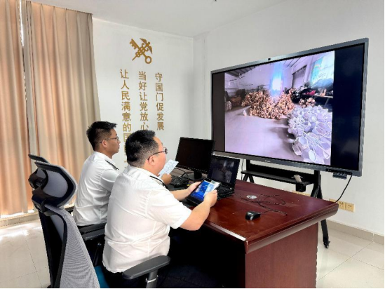 海關關員與企業人員通過手機遠程連線對企業出口竹木草制品進行檢查。鄭州海關供圖