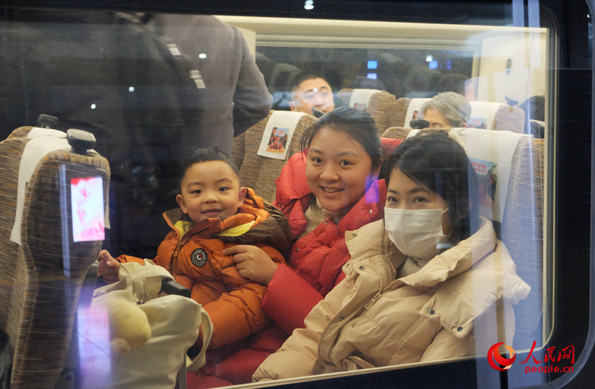 车厢里暖意融融，旅客们带着笑容踏上返乡旅途。人民网记者 常力元摄