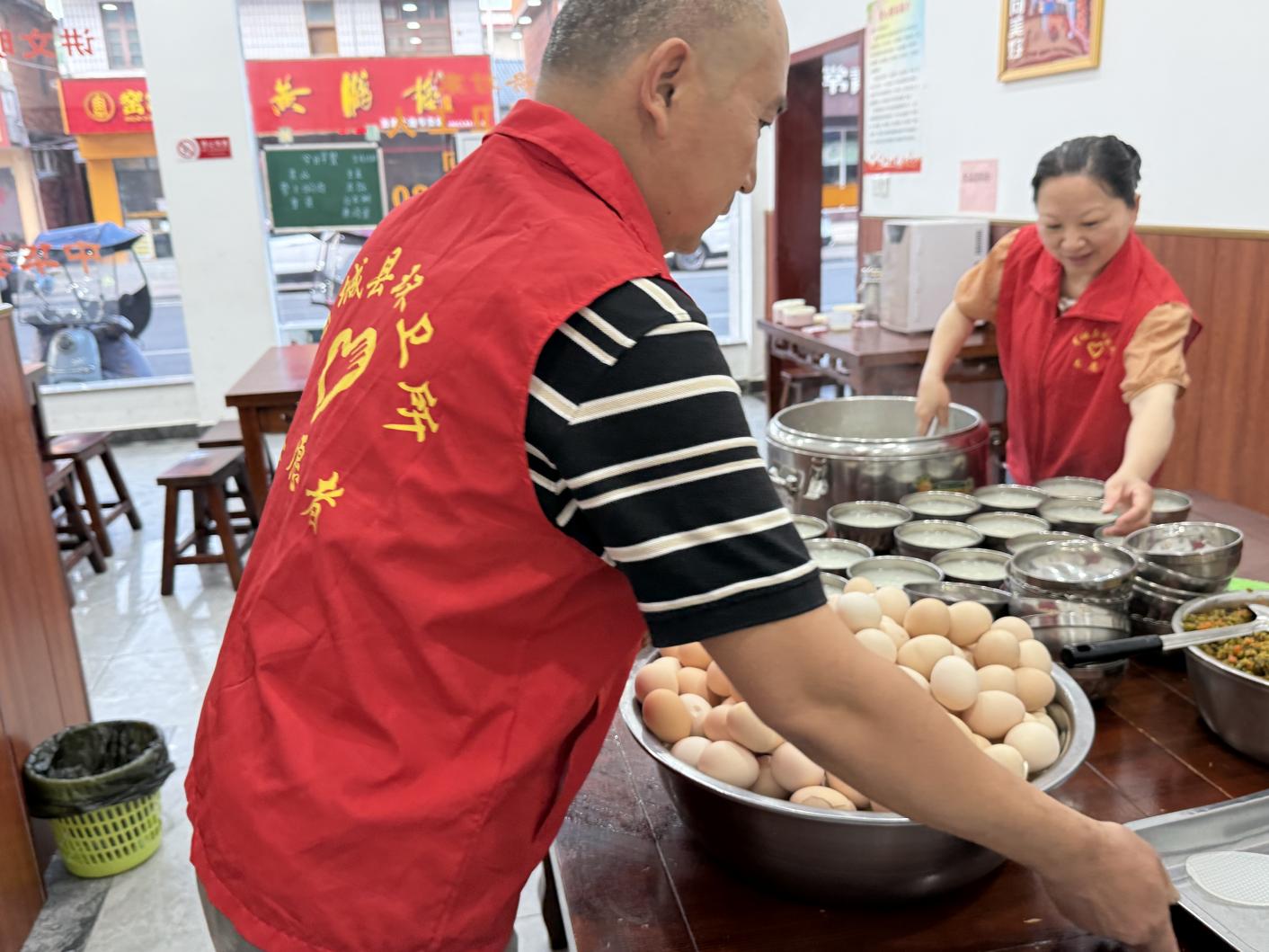 “大愛乾坤”公益早餐點的志願者在備餐。曾麗攝